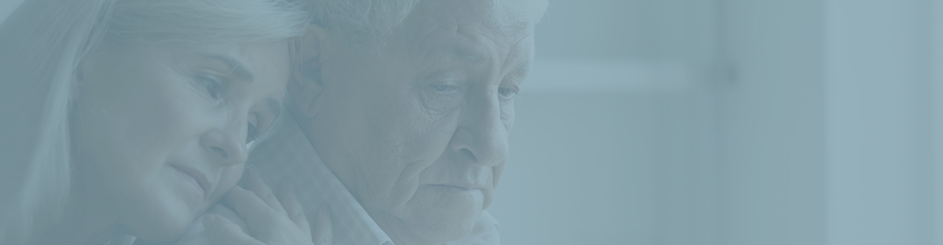 Woman comforting elderly man